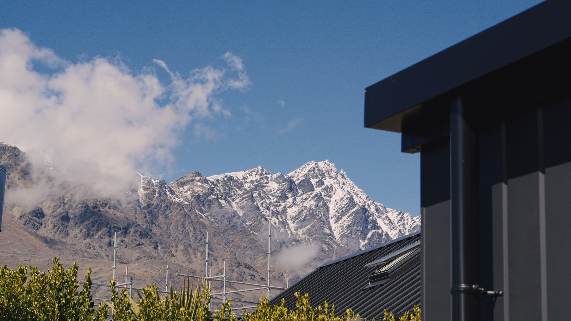 A snow-covered range seen over the roofline