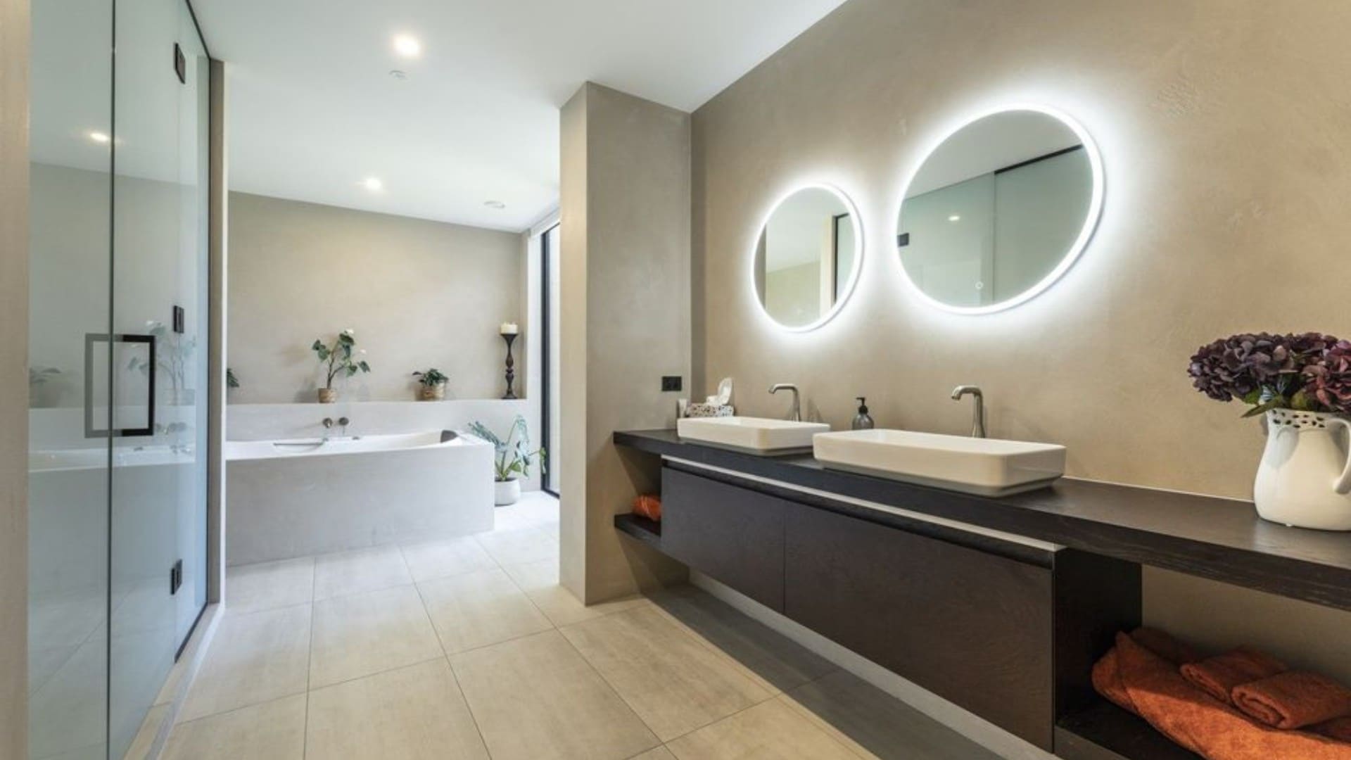 Bathroom with twin round mirrors on venetian plaster