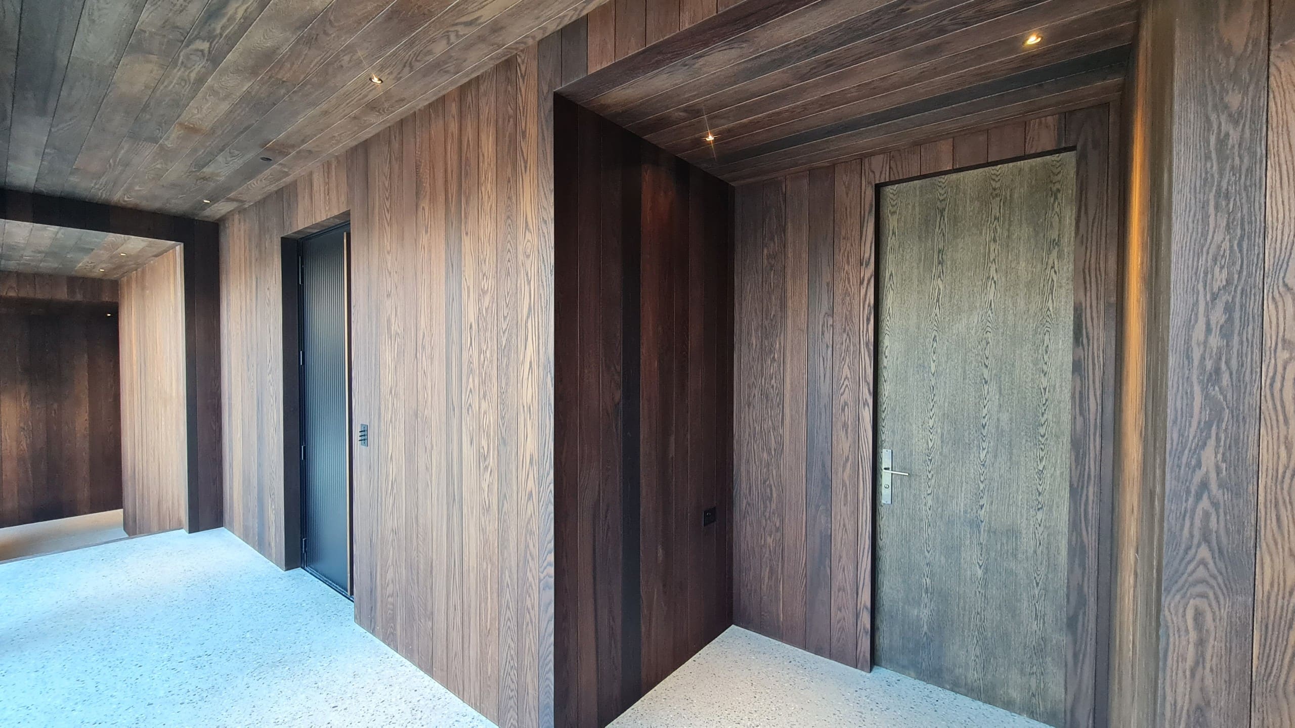 Oak door set into oak-lined walls and ceiling